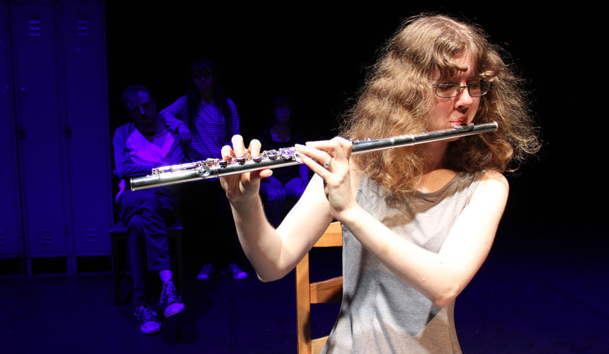 A woman playing the flute.